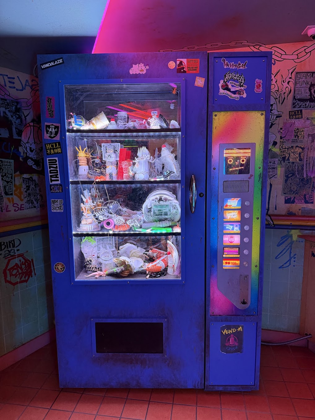 Neon-lit vending machine filled with strange objects at Meow Wolf Houston