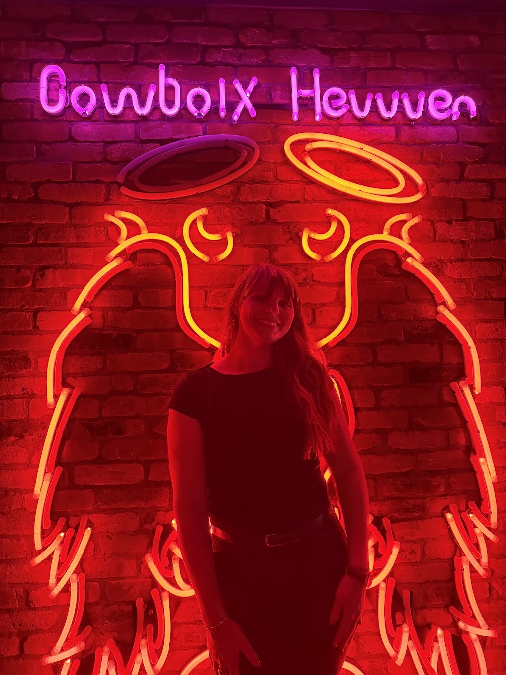 Cowboix Hevvven neon sign with angel wings at Meow Wolf Houston